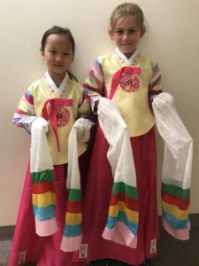 Two young girls in Korean hanbok traditional dresses.